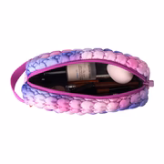 Pink and purple marbled cosmetic bag with makeup items on a white background