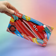 Colorful zipit pouch with a red zipper design held by a hand against a gradient background