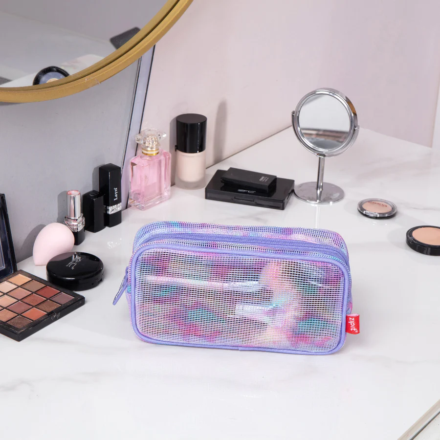 Makeup bag on a vanity with various cosmetics around