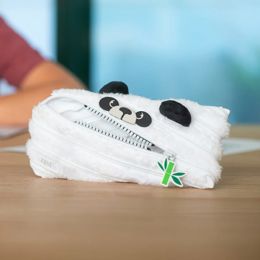 Panda-shaped plush toy with a zipper on a wooden surface