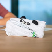 Panda-shaped plush toy with a zipper on a wooden surface