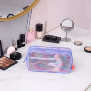 Makeup bag on a vanity with various cosmetics around